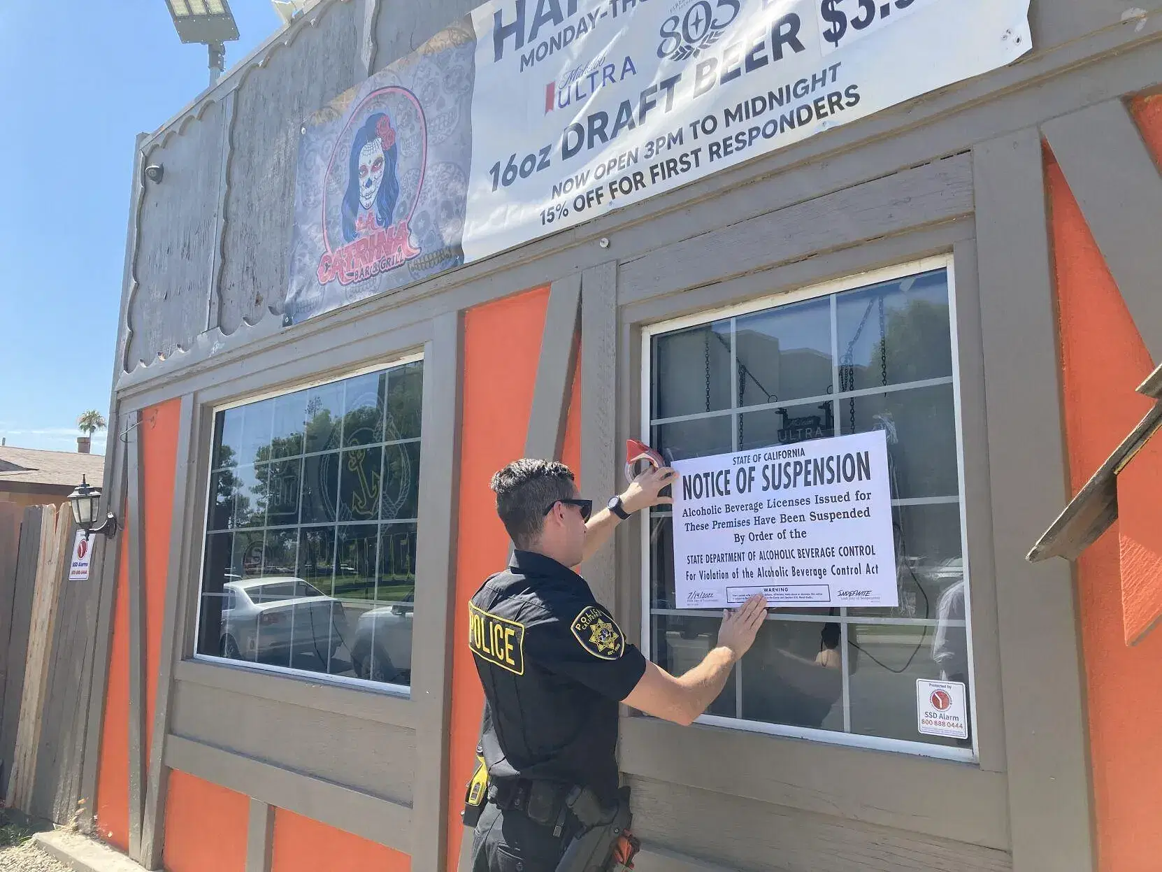 A police officer is enforcing responsible beverage service regulations.